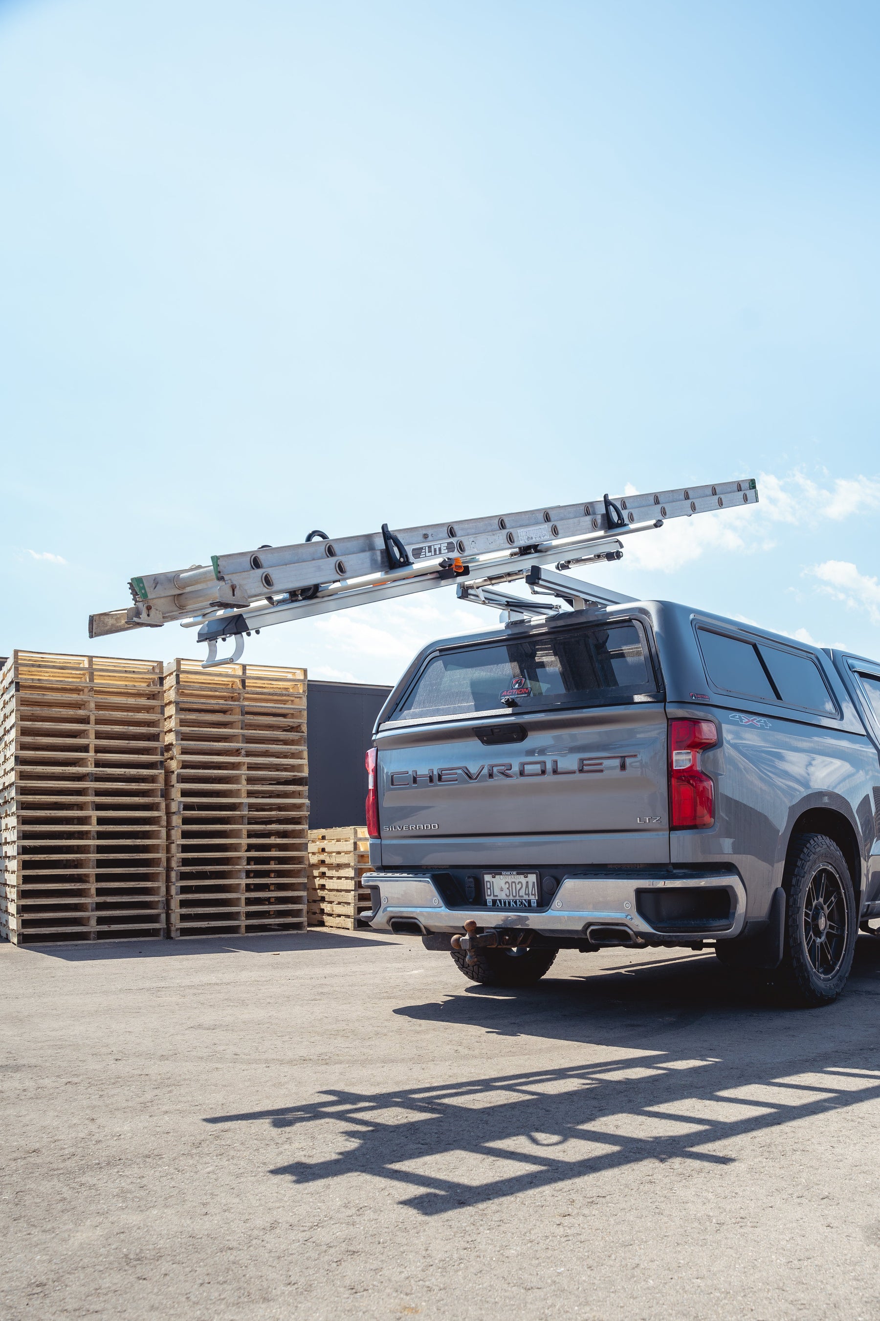Chevrolet truck with a ladder on a pallet in an outdoor setting